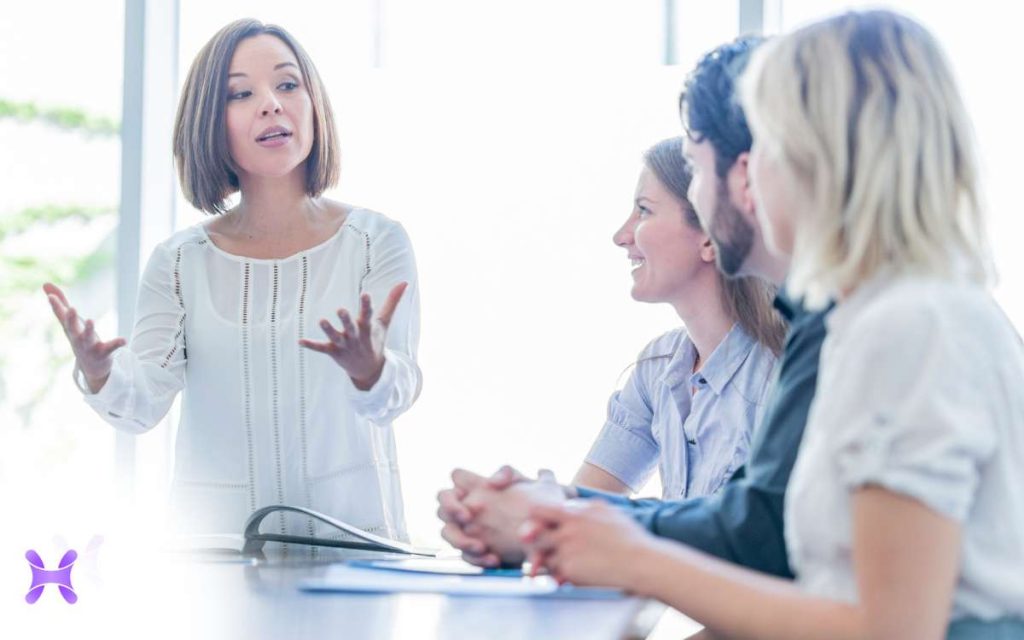 En la imagen se ve a una persona hablando con un equipo para implementar estrategias de inclusion laboral. 