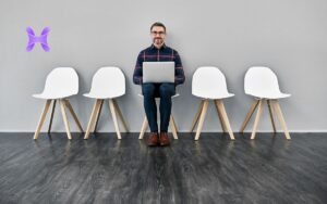 Vemos una imagen de una persona esperando una entrevista laboral, en relación con la búsqueda del candidato ideal para un puesto de trabajo.